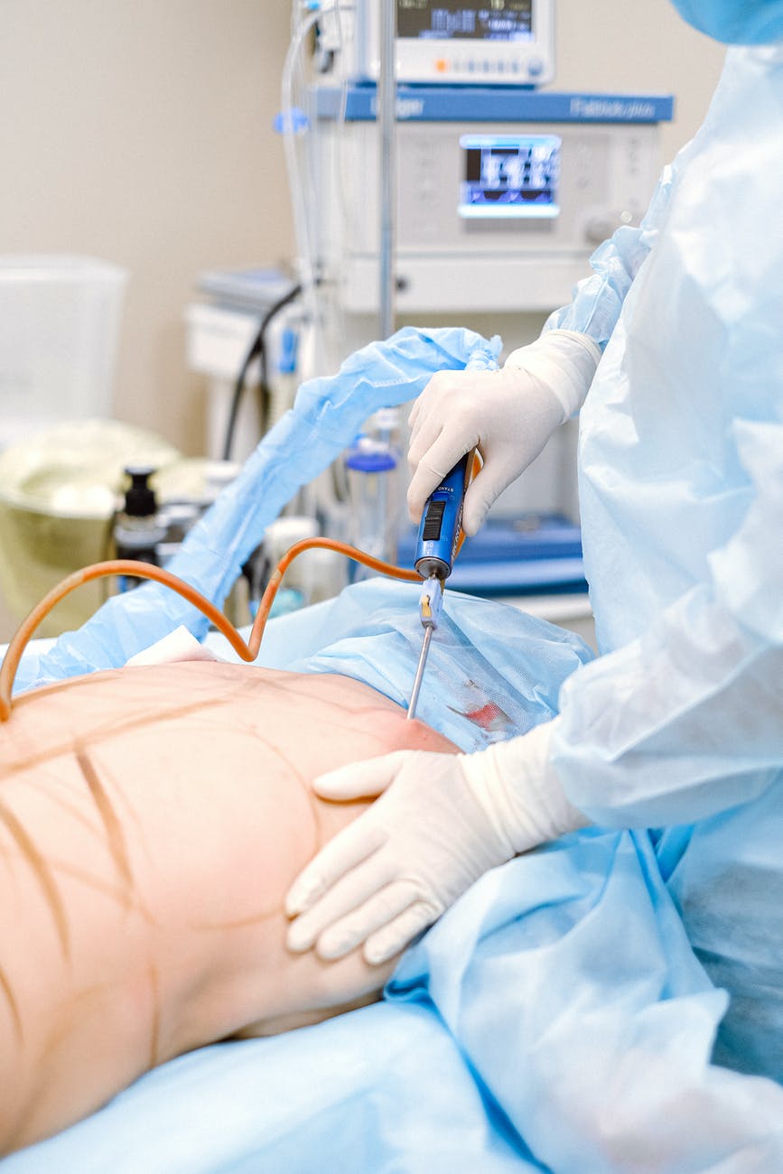 photo of medical professional doing a liposuction on a patient